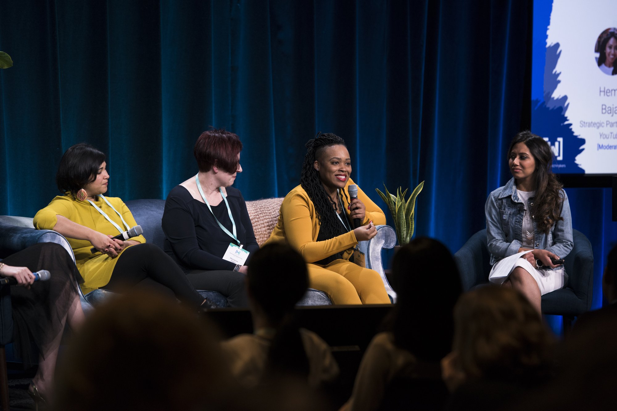 Rica Elysée speaking on a panel, seen from the audience