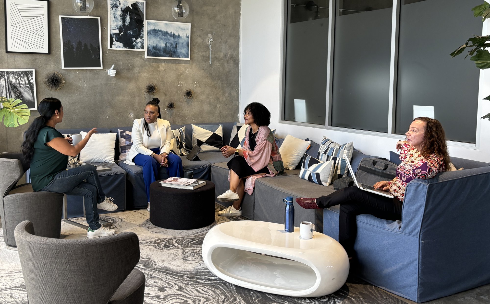Rica Elysée in a small-group conversation in a lounge